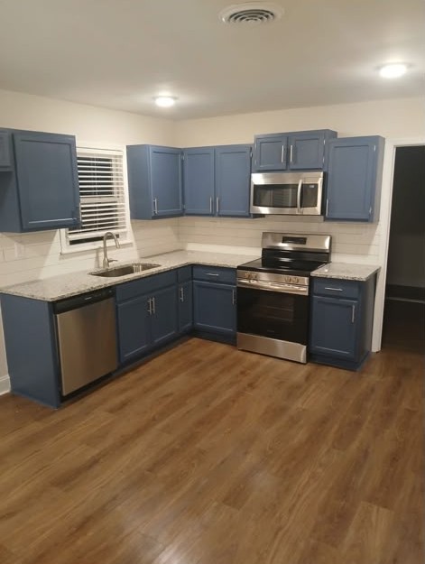 Kitchen Remodel — Blue Cabinets & Vinyl Flooring — Noyola Construction project in Huntsville, AL